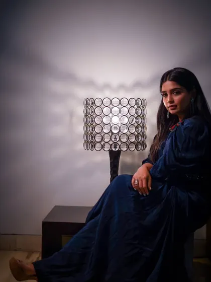 An elegant and moody portrait of actress Gouri G. Kishan. The creative lighting and her pose create a sophisticated and cinematic feel.