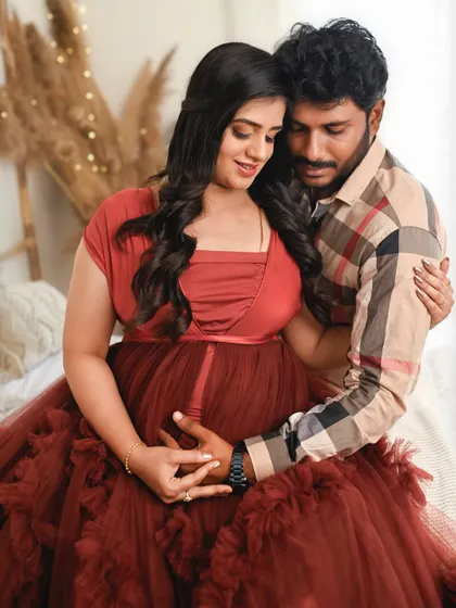 A close up showing the couple's hands on the baby bump. This pose is a beautiful way to symbolize their shared love and excitement for the baby.