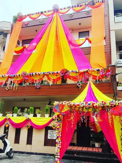 I specialize in turning your house into a true 'shaadi wala ghar'. This full-building transformation uses a vibrant combination of yellow and pink drapes, complete with a beautiful canopy entrance to welcome your guests in style.