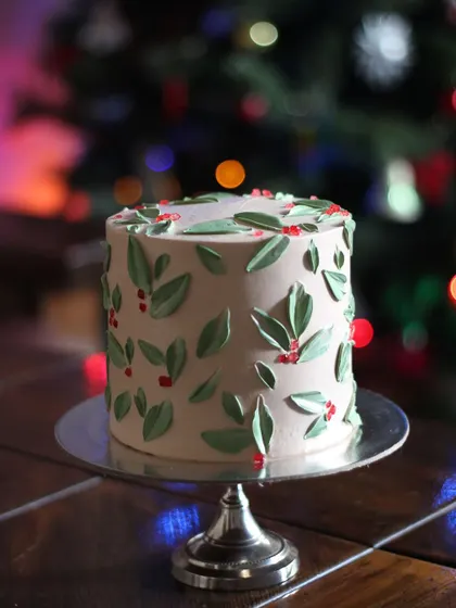 A festive holiday cake painted with holly leaves and red berries. The soft, neutral background makes the green and red pop. I couldn't decide which photo I liked best, so I'm sharing them all!