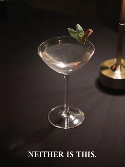Another image from our Negroni Week teaser series, showing a clear martini-style drink with the caption "Neither is this." This built curiosity for our unconventional Negroni menu.