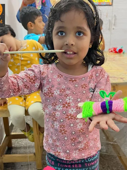 This student is proudly showing off the colorful yarn-wrapped butterfly she made. This craft is great for little hands to practice wrapping and color selection.