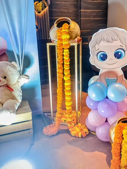 A close-up of the props from the fusion-style baby shower, showing the mix of modern cartoon cutouts, teddy bears, and traditional floral elements.