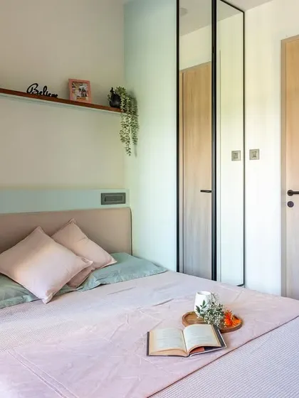 In this compact Mumbai bedroom, we used full-length mirrored wardrobe doors to create the illusion of spaciousness and reflect light.
