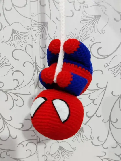The Spiderman plushie hanging upside down, as he should be.