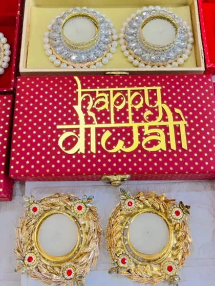 A close-up of the 'Happy Diwali' gift boxes, featuring ornate diya holders that are perfect for lighting up any home.