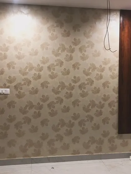 A classic floral damask wallpaper in neutral tones, adding subtle elegance to the room.