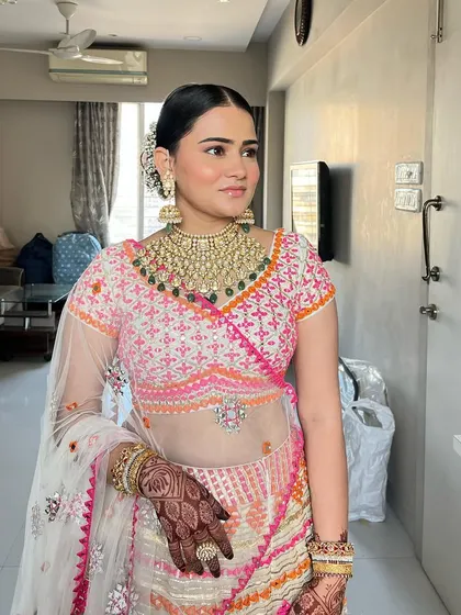Another angle of this stunning traditional look. The makeup is designed to be flawless and long-lasting, ensuring she looks perfect throughout the ceremony.