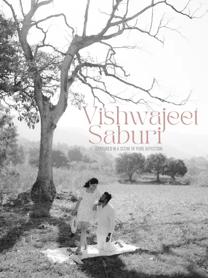 A beautiful black and white composition of a couple in a field, with their names elegantly written over the image. This is a perfect example of an artistic and personalized save the date photo.