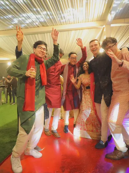 Friends and family celebrating on the dance floor. This high-energy group shot captures the fun and camaraderie of the wedding party.