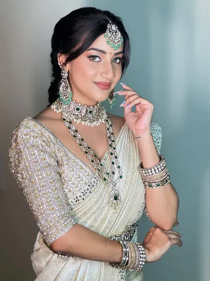 A portrait of elegance. This makeup look was designed to make her eyes the focal point, with a flawless base and soft lip color that balances the statement diamond and emerald jewellery.