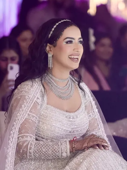 A candid moment of pure joy. This photo captures how the glittery, grand cocktail makeup comes alive when she smiles. The look was designed to be a showstopper, and her happiness makes it shine even brighter.