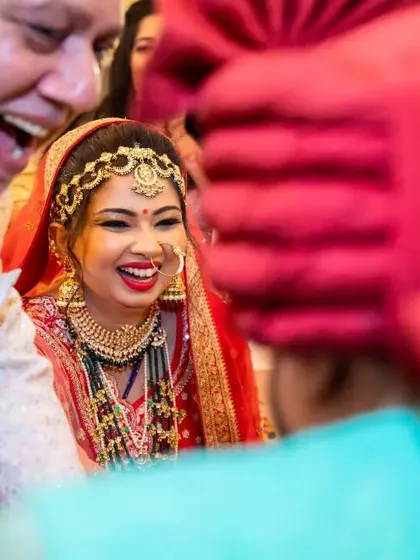 A candid moment of pure joy as the bride shares a laugh with her family during the wedding ceremony.