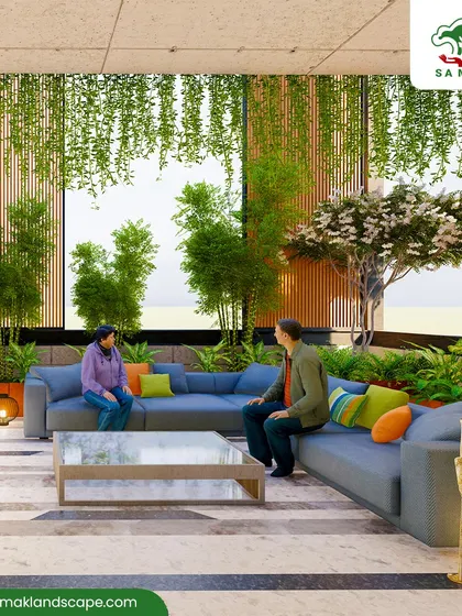 We transform large interior spaces, such as this corporate lobby, into vibrant atriums. The design uses multi-level planting with tall bamboo stalks, flowering trees, and cascading hanging plants to create a natural canopy over a central seating area, improving air quality and fostering a sense of tranquility.