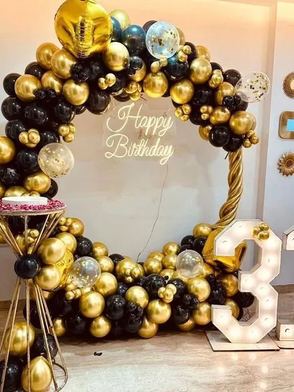 This black and gold themed 31st birthday is the definition of chic. We created a full circle balloon frame, added a custom neon "Happy Birthday" sign, and included large marquee numbers to create a glamorous photo-op for the celebration.