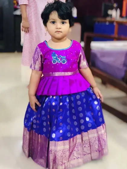 Here you can see the full outfit, with its vibrant purple and blue silk. The combination of the polka-dot pattern on the skirt and the unique blouse design makes this a truly one-of-a-kind piece.
