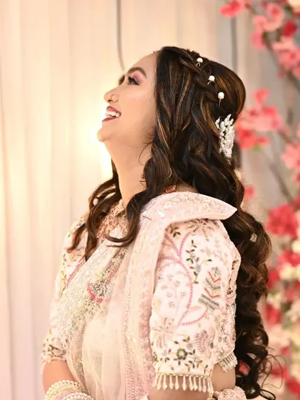 This engagement look was all about soft glam. I gave the bride-to-be flowing curls with a delicate hair accessory and makeup that enhanced her natural features.