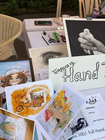 My setup at my first art stall. I had original sketches, prints, and even offered temporary hand tattoos. It was a great way to connect with people about my art.