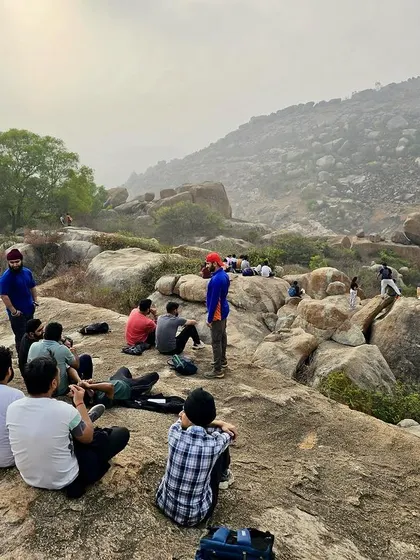 A group rests amidst the unique boulder-strewn landscape of Anthargange. This trek is as much about the journey through the rocks as the destination.