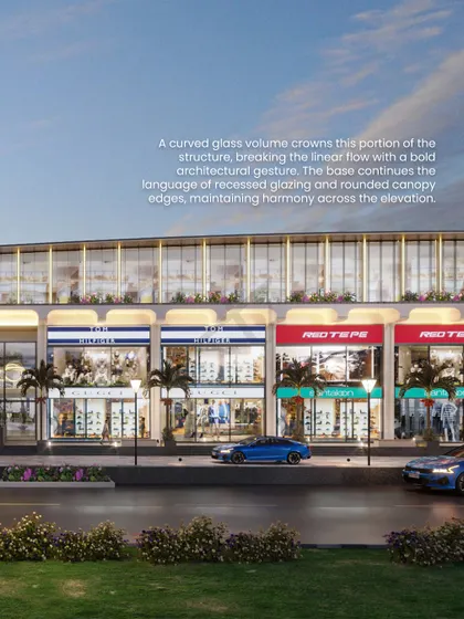 A curved glass volume crowns this portion of the structure, breaking the linear flow with a bold architectural statement.