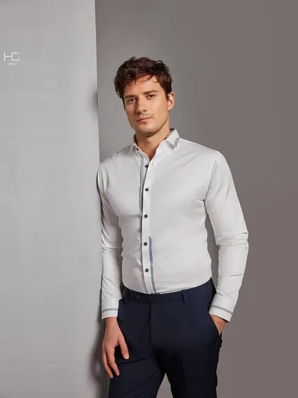 Make a statement with the perfect white shirt. This piece features subtle grey trim on the placket and cuffs, offering a modern update to a timeless wardrobe essential for any occasion.