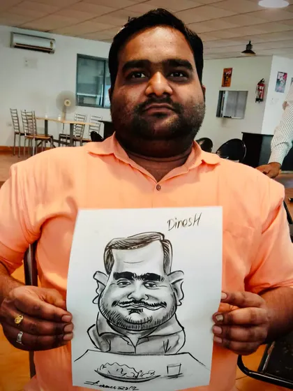 A guest holding his finished black and white caricature. The simplicity of the ink drawing puts all the focus on the exaggerated features and the subject's expression.