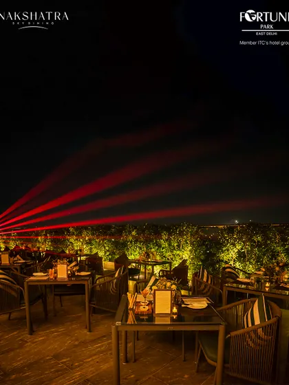 Laser lights cut across the night sky at Nakshatra, adding a dynamic visual element to our rooftop parties.