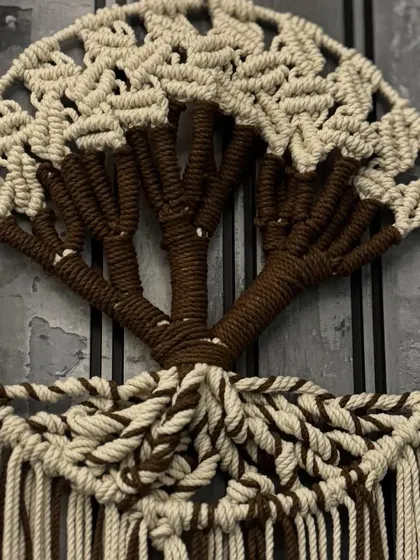 A close-up of the trunk and leaves of the macrame Tree of Life. I use different knotting techniques to create the detailed design.