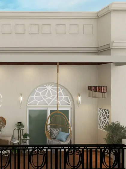 Another angle of the balcony, showing the boho lighting and the arched doorway with a geometric jali pattern.