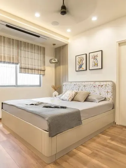 A full view of the bedroom, showing the custom bed with floral headboard, matching wardrobe, and elegant dresser unit.