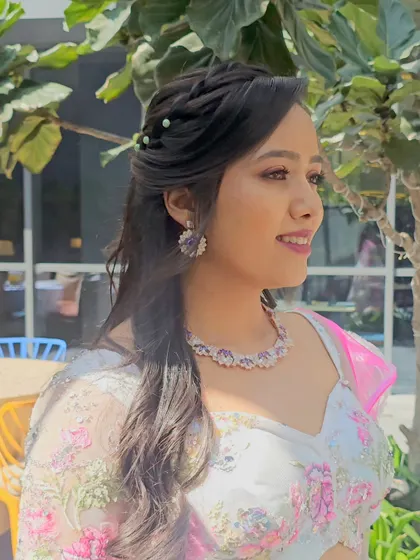 A side profile highlighting the intricate hairstyle and glowing makeup that perfectly complemented her features.