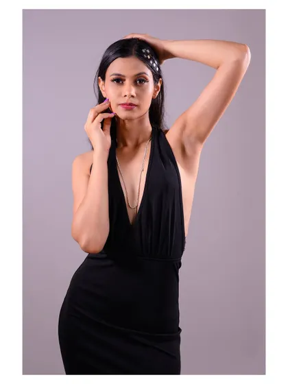 This pose, with the model's hands framing her face, adds a touch of classic glamour to the shot.