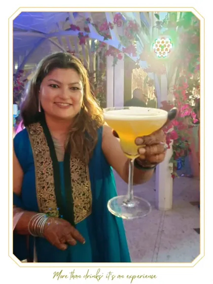 A happy bride holding her personalized cocktail. The custom monogram adds a special touch that is both elegant and perfect for photos.