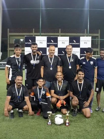 The winning team, AECS FC-A, posing with their medals and trophies after a hard-fought corporate tournament at our arena.