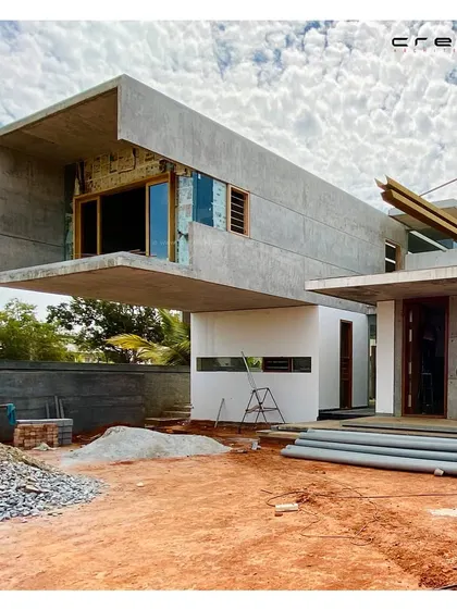 The Quarry House during construction, showing the dramatic cantilevered form before the installation of landscaping and exterior finishes.