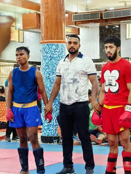 Another moment of victory. Standing between two warriors after their bout, showing respect for both.