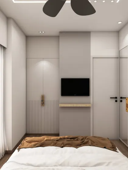 The integrated TV and storage unit in this bedroom is designed to be sleek and unobtrusive, maintaining the room's clean and modern aesthetic.