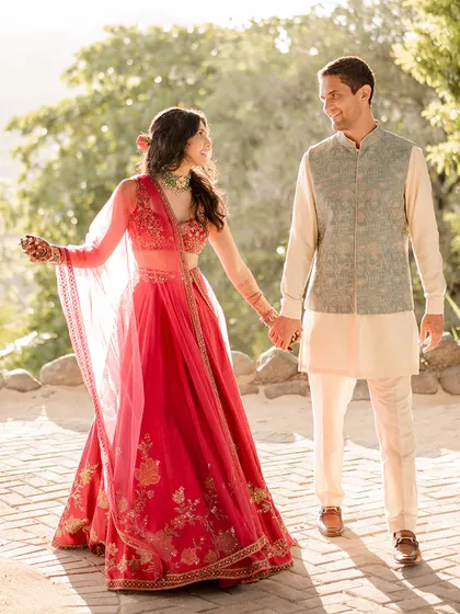 A sun-kissed moment during their Sangeet in Costa Rica. The light catches the details of their beautifully styled, coordinated outfits.