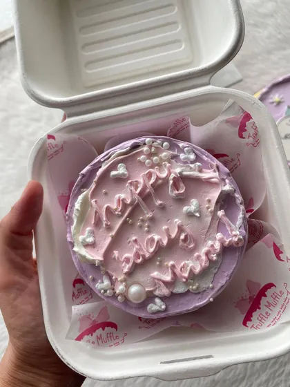 This abstract purple and pink bento cake is decorated with little hearts and pearls. It's a great example of a simple, pretty design for any occasion.