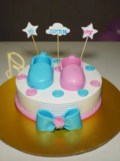 A detailed photo of the baby shower cake with blue and pink booties. These shots are perfect for remembering the theme of your celebration.