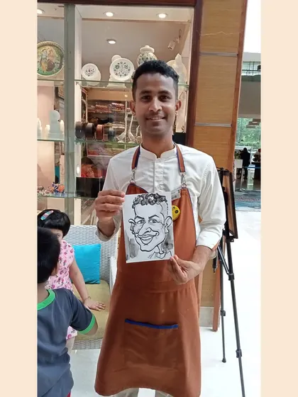 A member of the hotel staff took a moment to get his caricature done. It's fun for everyone, including the hosts.