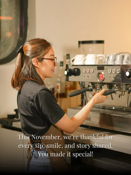 This November, we're thankful for every sip, smile, and story shared. A shot of our barista at the espresso machine, crafting drinks with care.