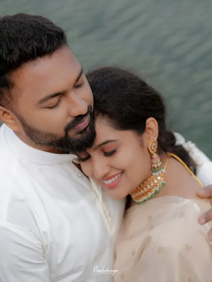 A close-up of a tender hug, focusing on the genuine smiles and affection shared between the couple.