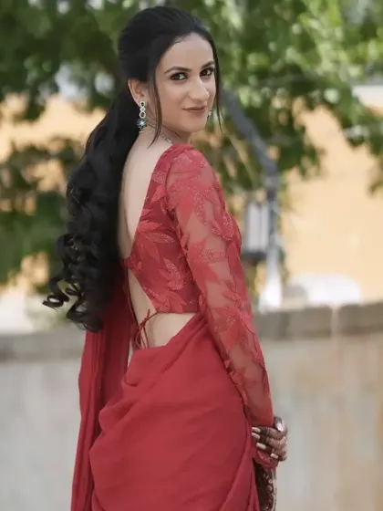 A duplicate of image 11, showing the beautiful flow of the hair and saree. This modern hairstyle is perfect for a reception or cocktail party.