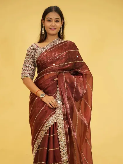 This ready-to-wear organza saree in a rich maroon hue is designed for grand entrances. The gota patti border and sequin work add a touch of sparkle, while the pre-stitched design ensures you look flawless in seconds.