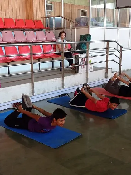 Fitness is a cornerstone of our training philosophy. This image shows a flexibility and strength session in progress. We believe a strong body supports a steady hand and a focused mind.