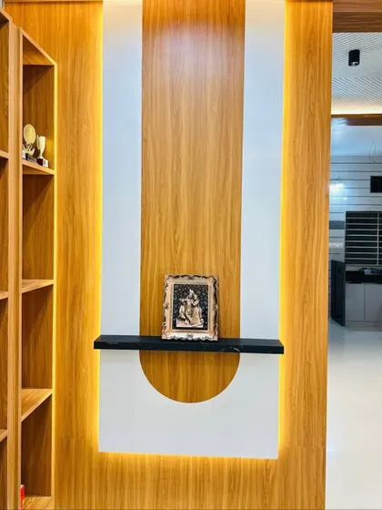A detailed shot of the backlit partition wall, designed to create a warm glow and highlight the decor placed on the floating shelf.