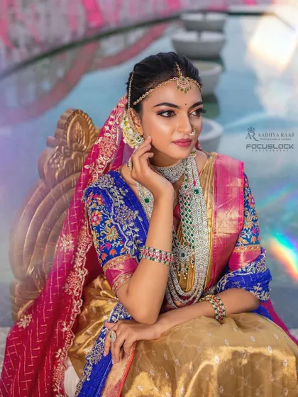 A fusion look combining a traditional half-saree with modern layered jewelry. This set features a diamond-simulant choker and a long haram with green beads, showing how my pieces can be styled for unique, contemporary events.