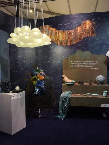 A curated display for the 'Into The Deep' theme. The scene includes sculptural objects, a cloud-like chandelier, and a custom garment, all designed to evoke the magical and mysterious landscape of the sea.
