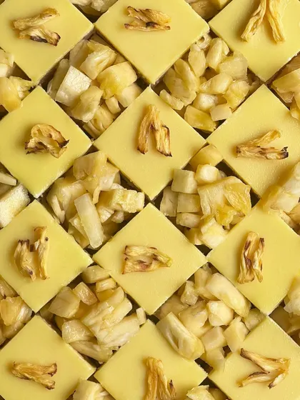 The tropical flavors of my pineapple opera gateau are on full display here. The bright yellow of the cake contrasts beautifully with the chunks of dried and fresh pineapple.